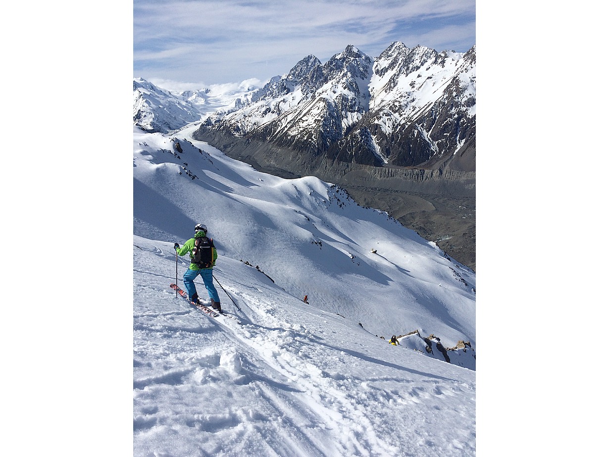 A skier pauses on the descent below Caroline Hut